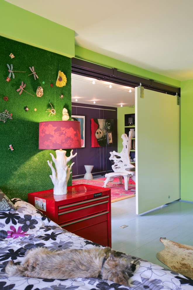 This is an example of an eclectic bedroom in New York with green walls.