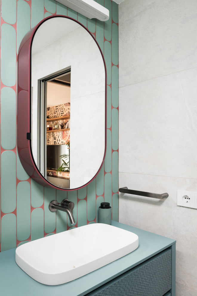 Inspiration for a small cloakroom in Rome with flat-panel cabinets, green cabinets, a wall mounted toilet, green tiles, ceramic tiles, green walls, porcelain flooring, a built-in sink, grey floors, turquoise worktops and a floating vanity unit.