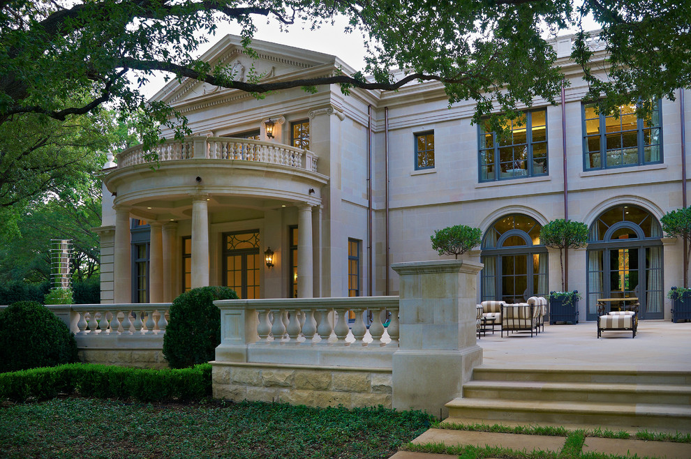 This is an example of an expansive traditional two-storey exterior in Dallas with stone veneer.