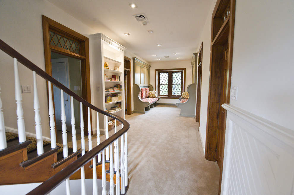 Traditional hallway in Philadelphia with white walls, carpet and beige floor.