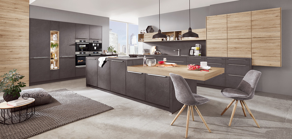 Large modern l-shaped eat-in kitchen in Other with an integrated sink, beaded inset cabinets, grey cabinets, laminate benchtops, grey splashback, slate splashback, panelled appliances, concrete floors, with island, grey floor and grey benchtop.