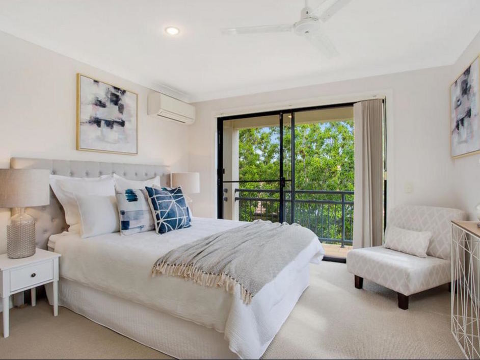 This is an example of a mid-sized contemporary master bedroom in Gold Coast - Tweed with beige walls, carpet and beige floor.