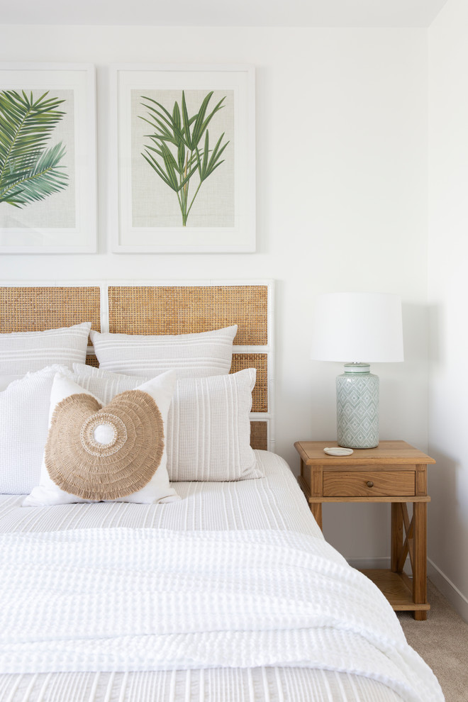This is an example of a mid-sized beach style guest bedroom in Gold Coast - Tweed with white walls, carpet and beige floor.