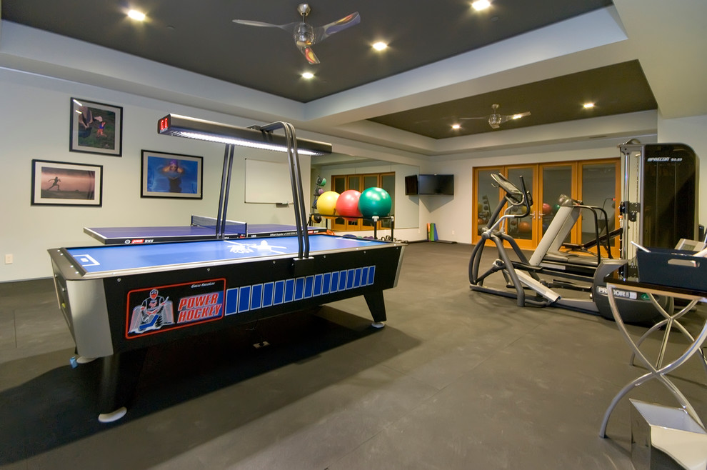 Contemporary home gym in San Francisco with concrete floors.