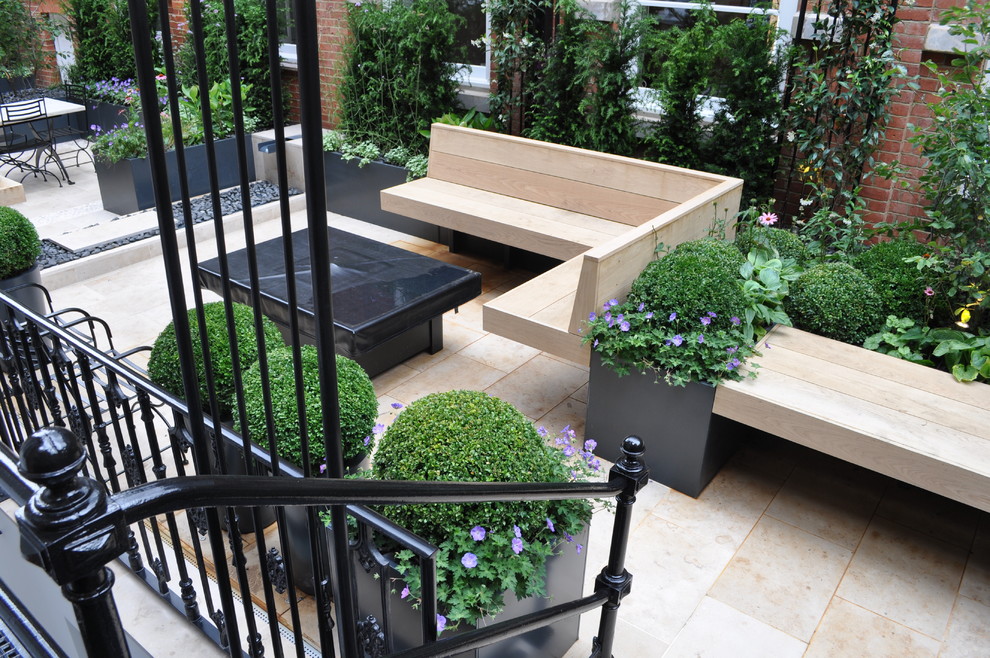 This is an example of a small contemporary rooftop deck in Hertfordshire with a water feature.