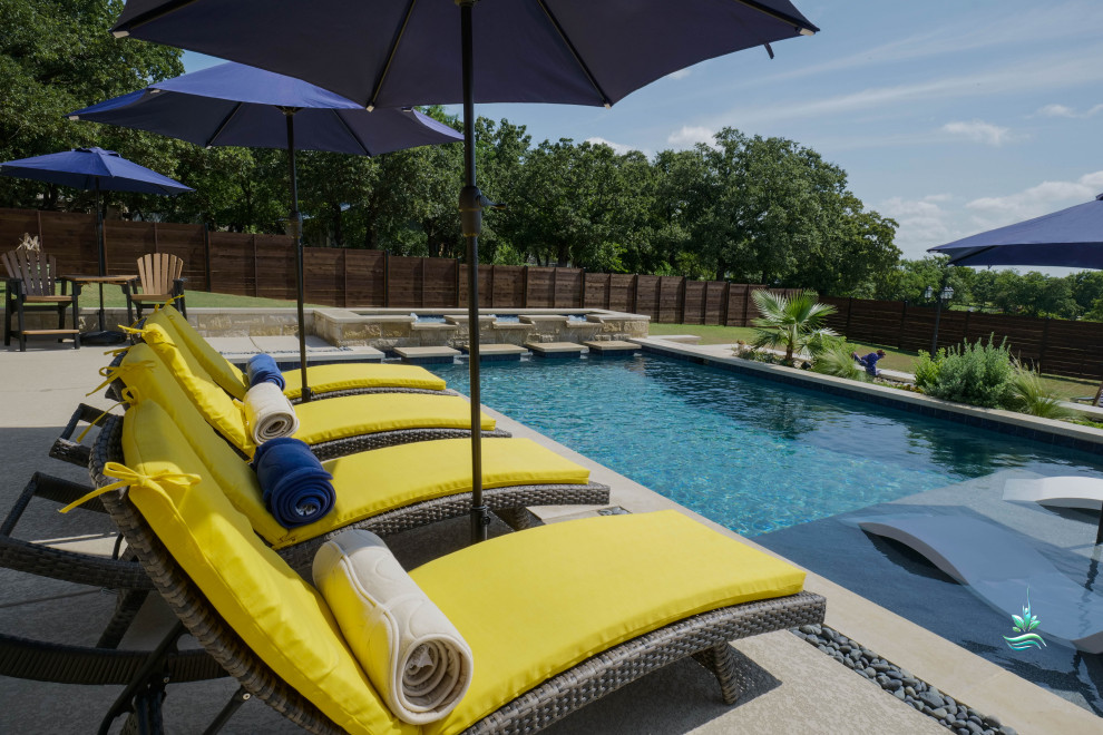 Huge tuscan backyard custom-shaped infinity pool landscaping photo in Dallas with decking