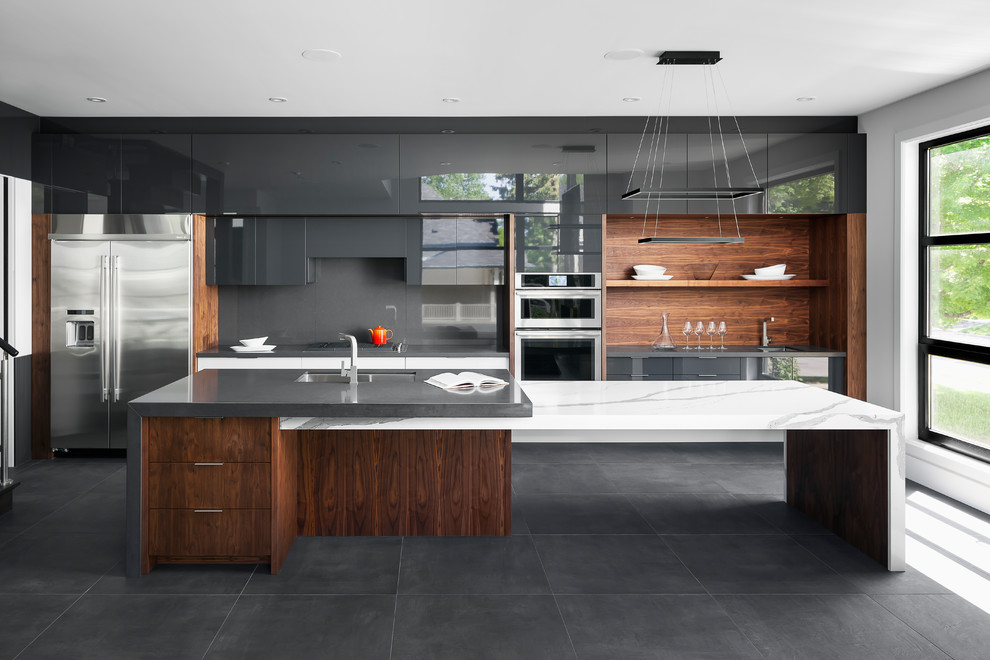 This is an example of a large contemporary galley eat-in kitchen in Other with an undermount sink, flat-panel cabinets, grey cabinets, quartz benchtops, grey splashback, stone slab splashback, stainless steel appliances, porcelain floors, with island and grey floor.