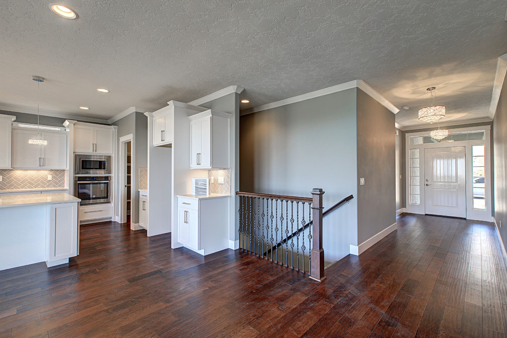 Small transitional medium tone wood floor front door photo in Seattle with gray walls and a white front door