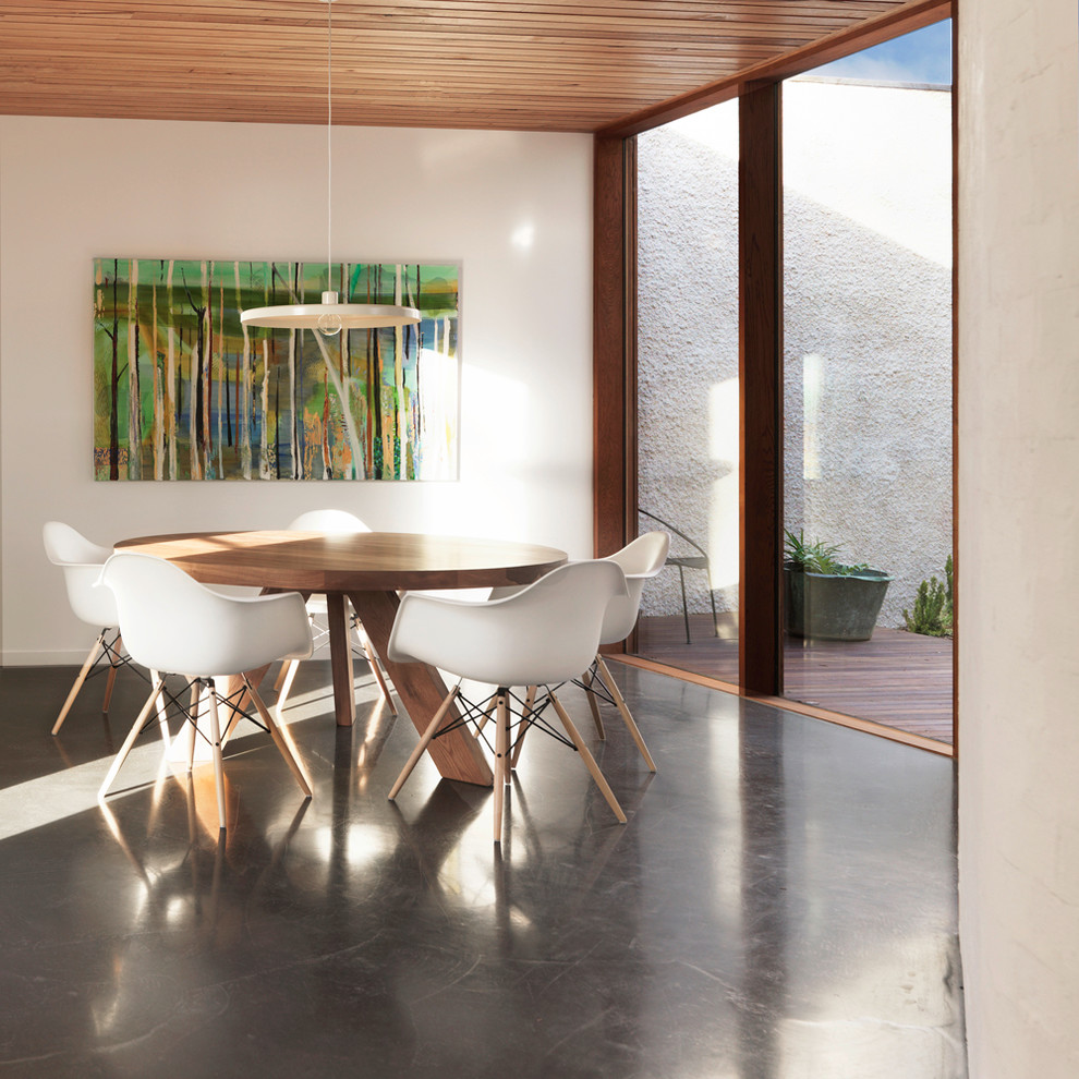 Design ideas for a mid-sized contemporary dining room in Geelong with concrete floors, white walls and no fireplace.