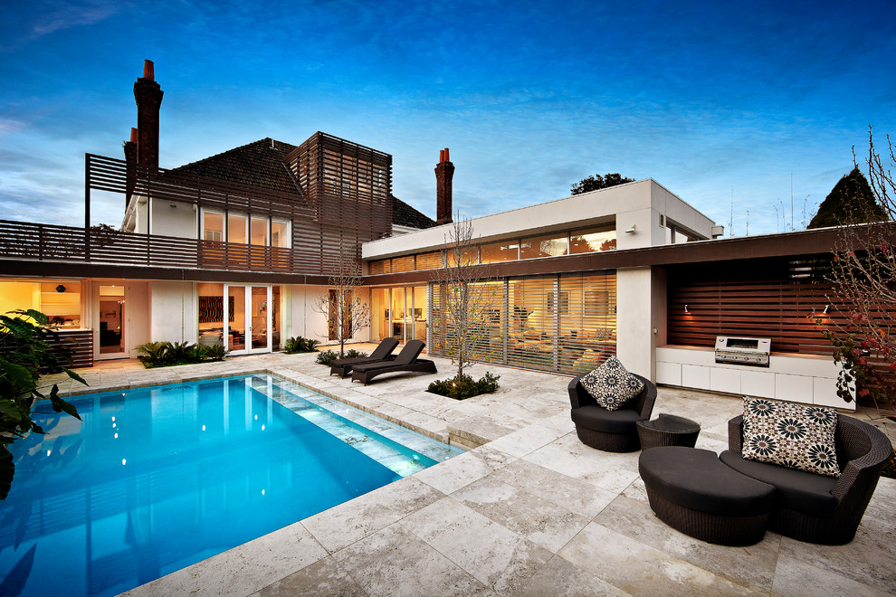 This is an example of a contemporary backyard rectangular pool in Melbourne.