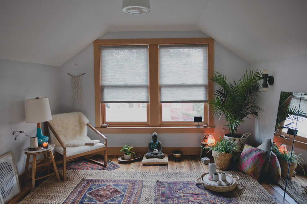 Design ideas for a mid-sized transitional home yoga studio in Portland with white walls and light hardwood floors.
