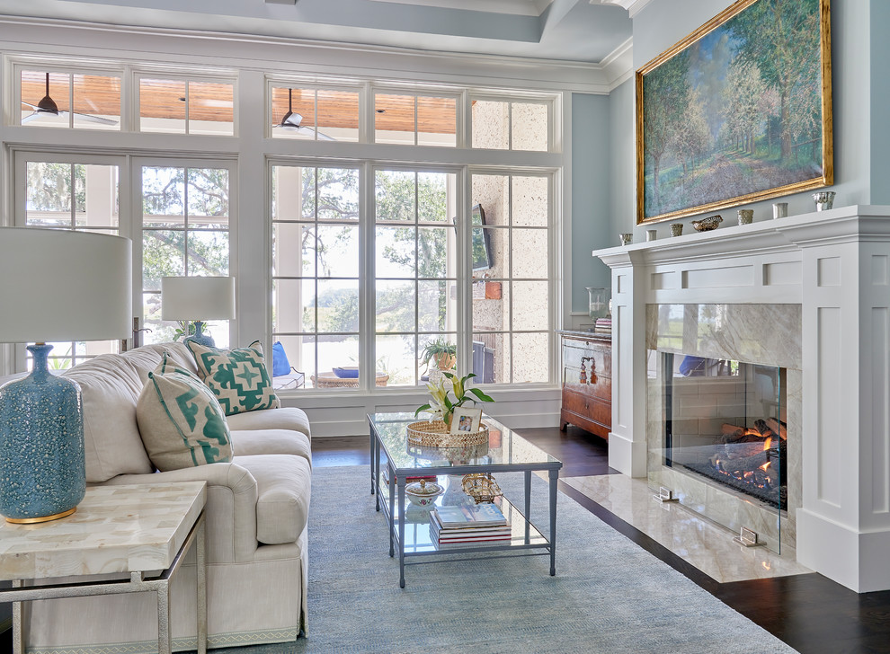 Inspiration for a mid-sized transitional formal open concept living room in Charleston with dark hardwood floors, a standard fireplace, a stone fireplace surround, brown floor, blue walls and no tv.