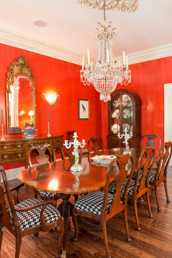 Photo of a traditional dining room in Columbus with red walls and medium hardwood floors.