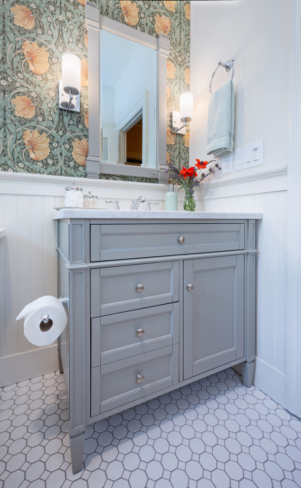 Small traditional bathroom in Sacramento with shaker cabinets, grey cabinets, an alcove tub, a shower/bathtub combo, a two-piece toilet, white tile, ceramic tile, ceramic floors, an undermount sink, marble benchtops, white floor, a shower curtain, white benchtops, a single vanity, a freestanding vanity and wallpaper.