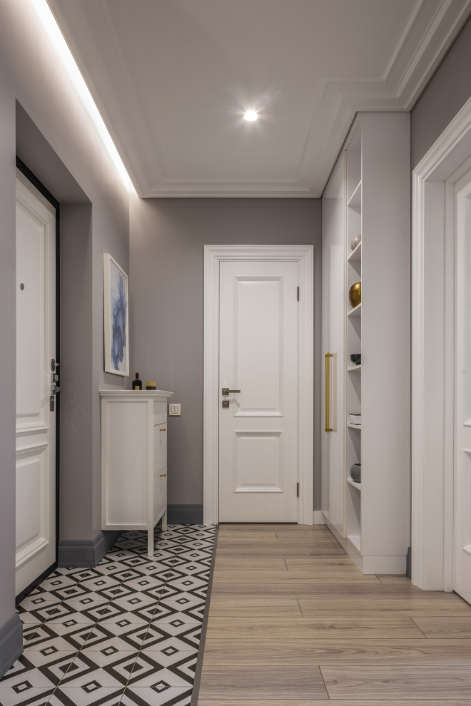 This is an example of a small contemporary front door in Other with grey walls, laminate floors, a white front door and beige floor.
