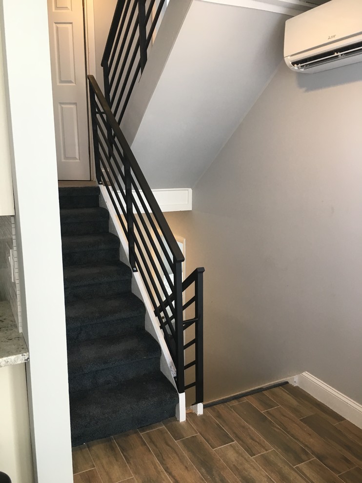 Example of a mid-sized classic carpeted u-shaped metal railing staircase design in Philadelphia with carpeted risers