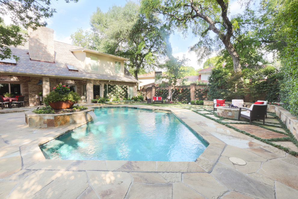 Example of a large transitional backyard stone and custom-shaped water slide design