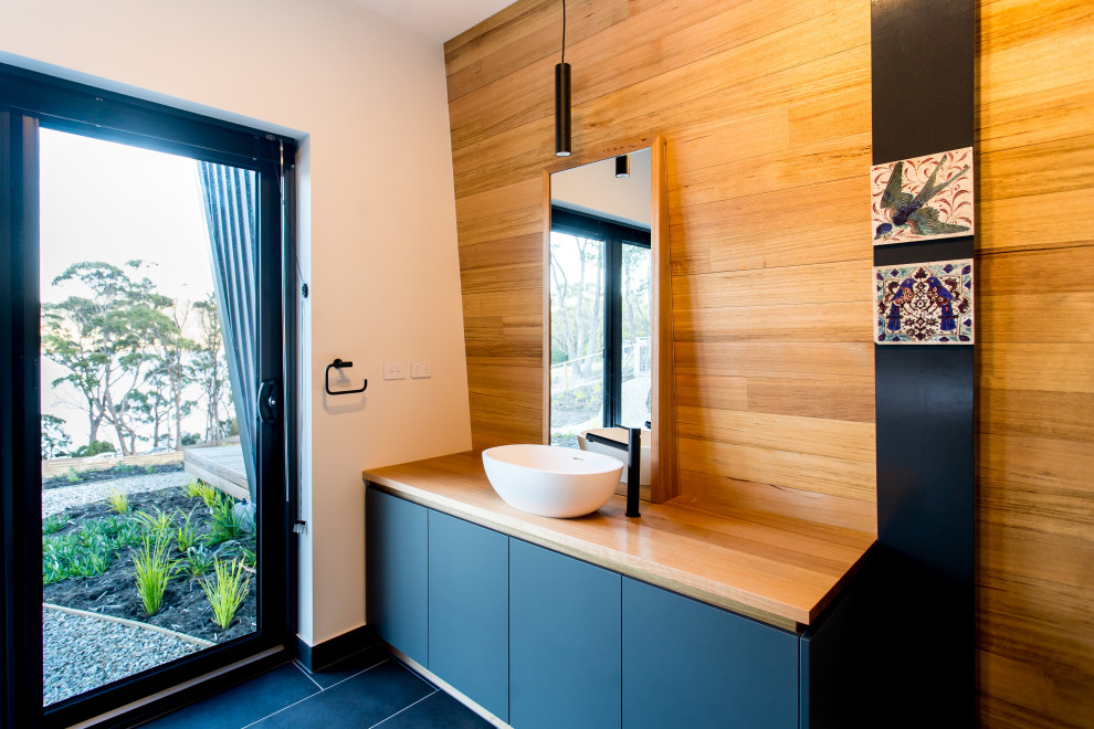 Photo of a contemporary bathroom in Hobart with porcelain flooring, wooden worktops, black floors and a built in vanity unit.