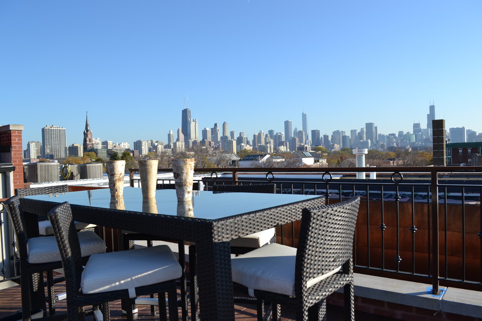 Large contemporary rooftop deck in Chicago with a fire feature and a pergola.