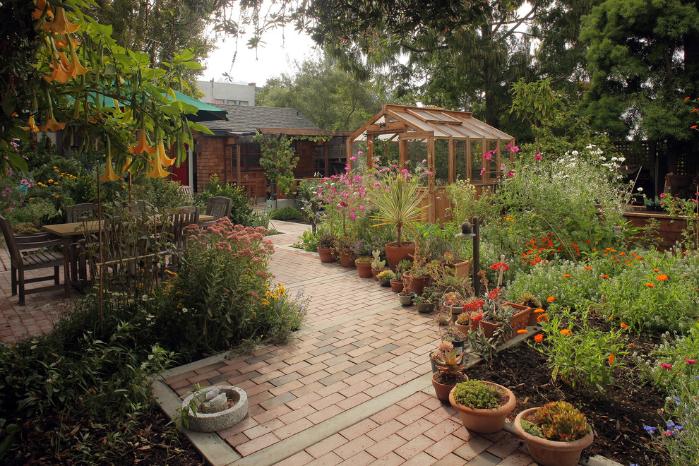 Large country backyard full sun garden in San Francisco with a garden path and brick pavers.