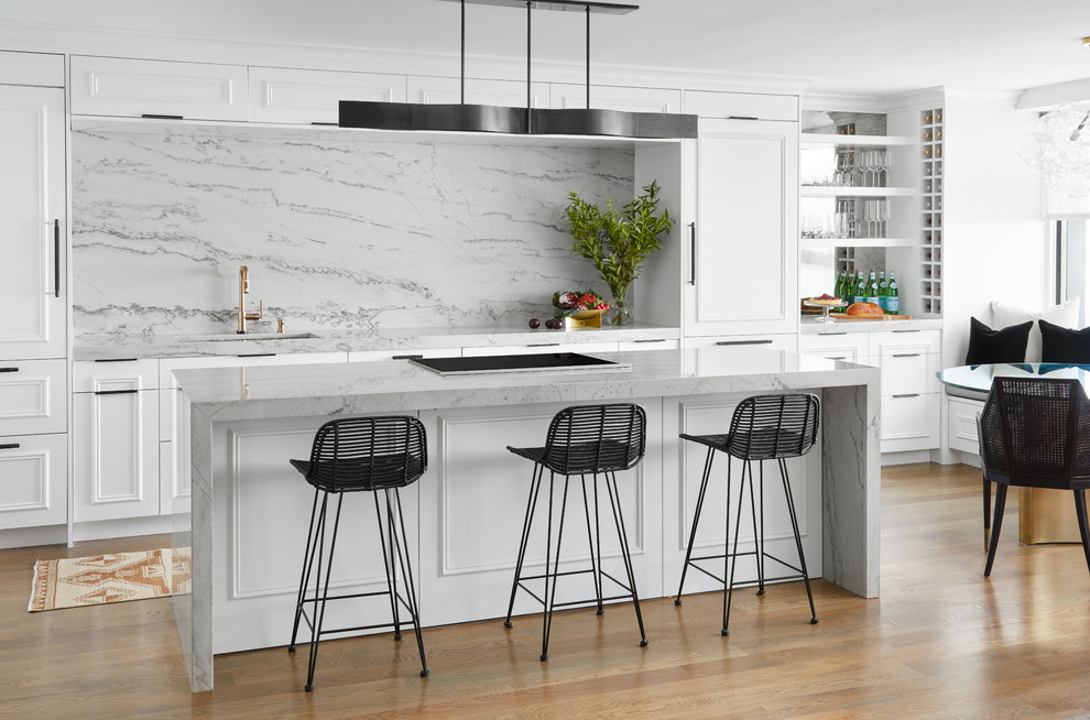 Inspiration for a large contemporary single-wall eat-in kitchen in Chicago with an undermount sink, white cabinets, quartzite benchtops, grey splashback, stone slab splashback, panelled appliances, medium hardwood floors, with island and grey benchtop.