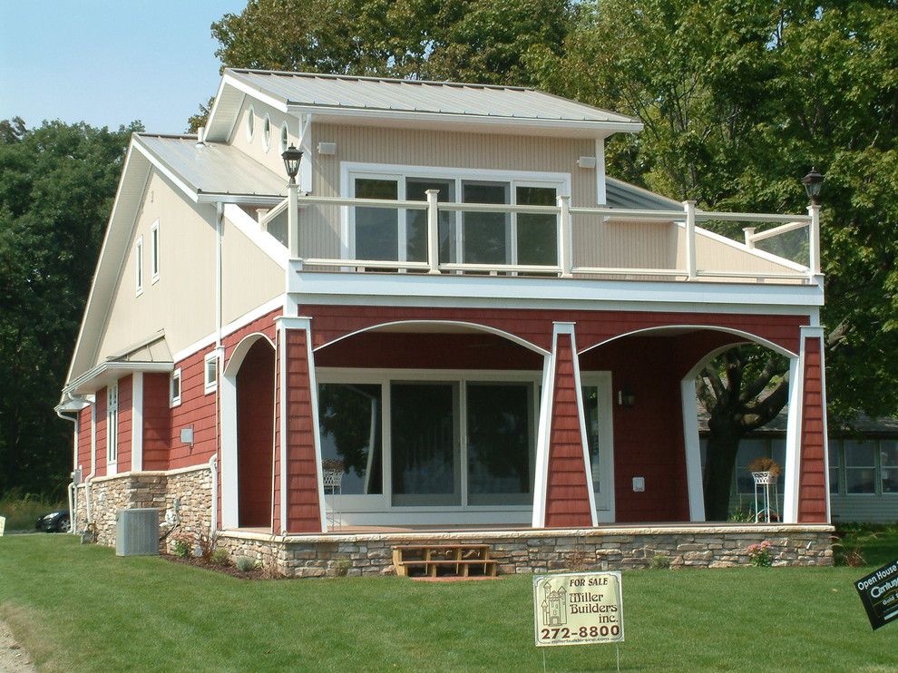 Design ideas for a small arts and crafts two-storey red exterior in Chicago with vinyl siding.