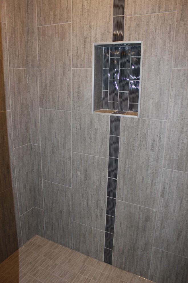 Corner bathtub - transitional gray tile and mosaic tile ceramic tile corner bathtub idea with shaker cabinets, dark wood cabinets, granite countertops and beige walls
