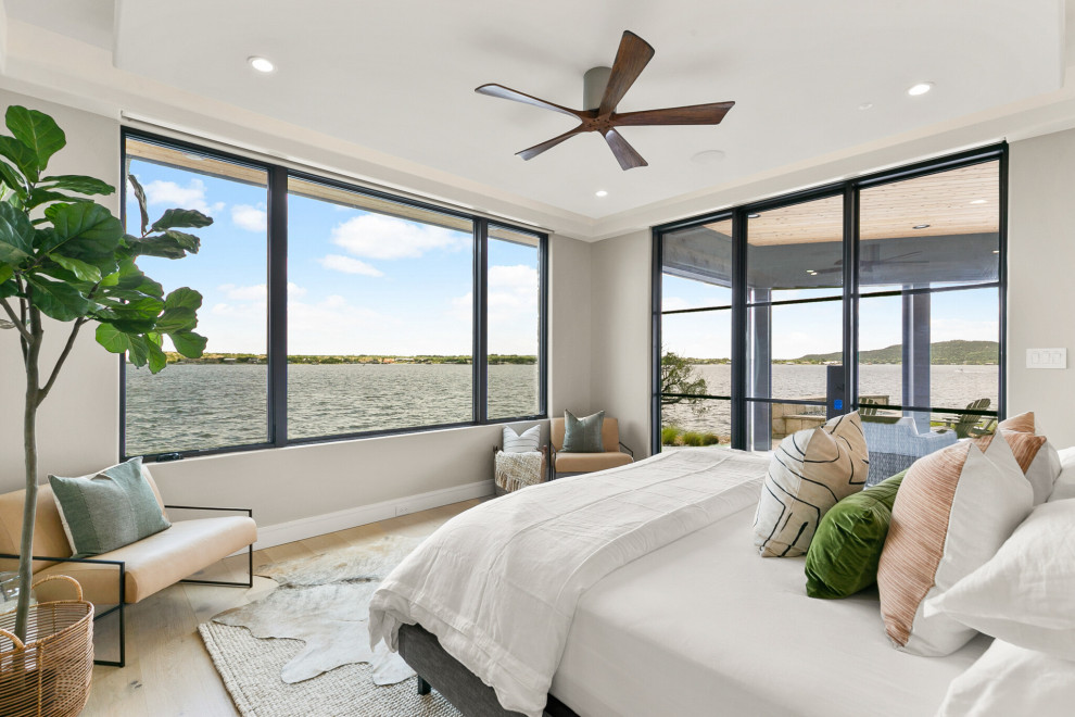 Inspiration for a mid-sized coastal master light wood floor bedroom remodel in Dallas with gray walls