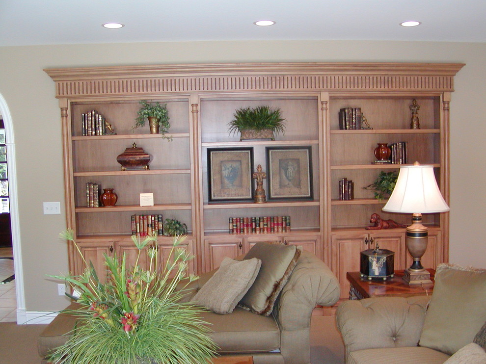 This is an example of a traditional living room in Grand Rapids with beige walls and carpet.