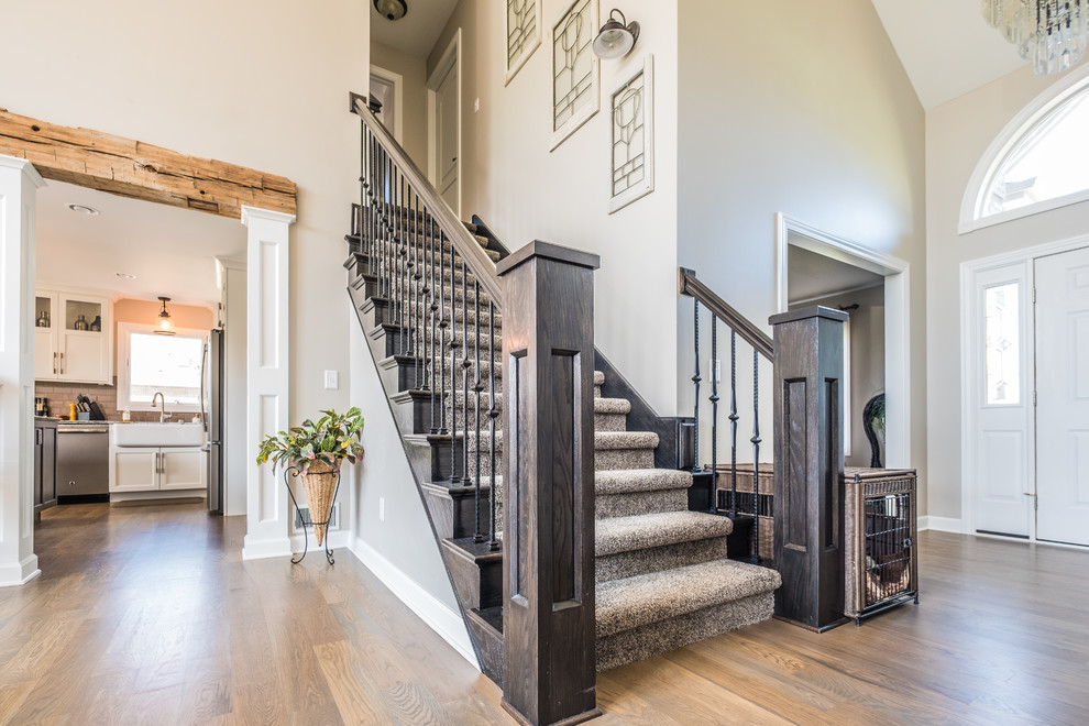 This is an example of a mid-sized transitional wood straight staircase in Detroit with wood railing and wood risers.