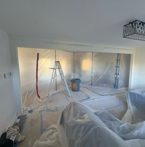 Existing kitchen and living area prior to structural modifications. The project involved removing interior walls to create a more open floor plan and improve the flow between the kitchen and adjoining