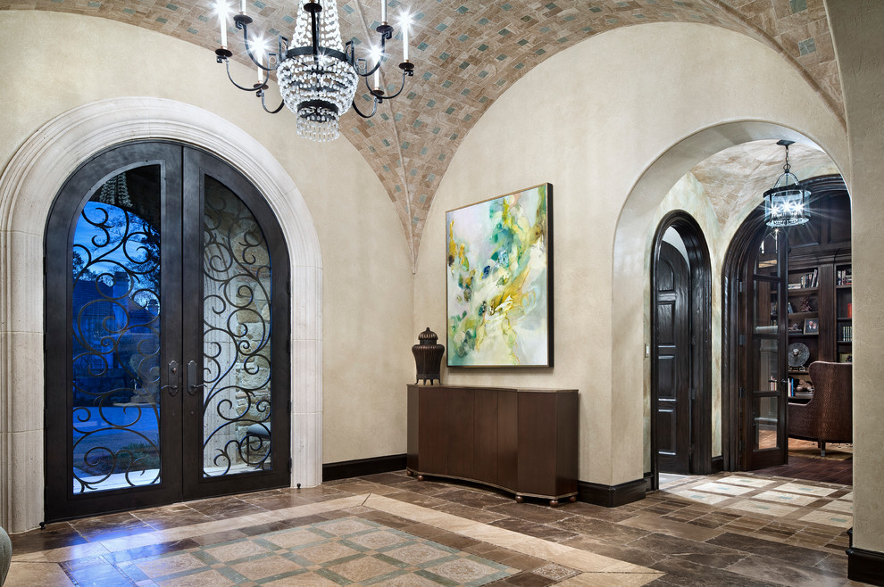 Design ideas for a mediterranean foyer in Houston with beige walls, a double front door and a glass front door.