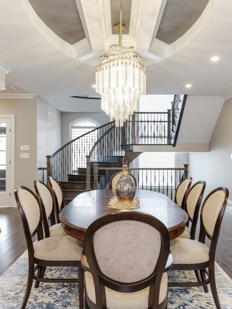 Classic dining room in Ottawa with dark hardwood flooring, a standard fireplace and a coffered ceiling.