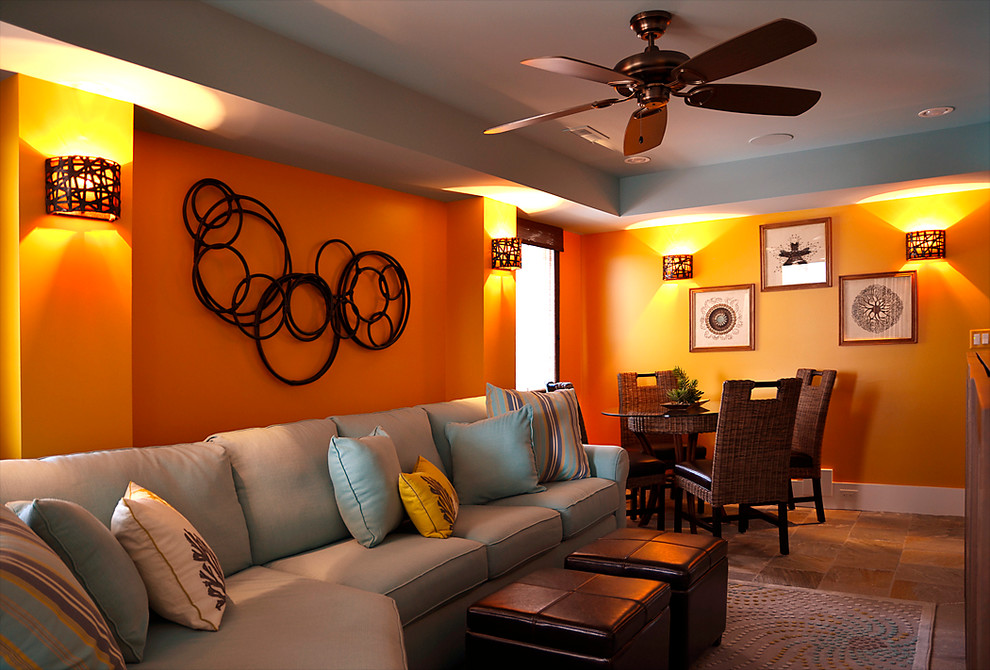 Photo of an expansive beach style open concept family room in Philadelphia with a game room, orange walls, light hardwood floors and a wall-mounted tv.