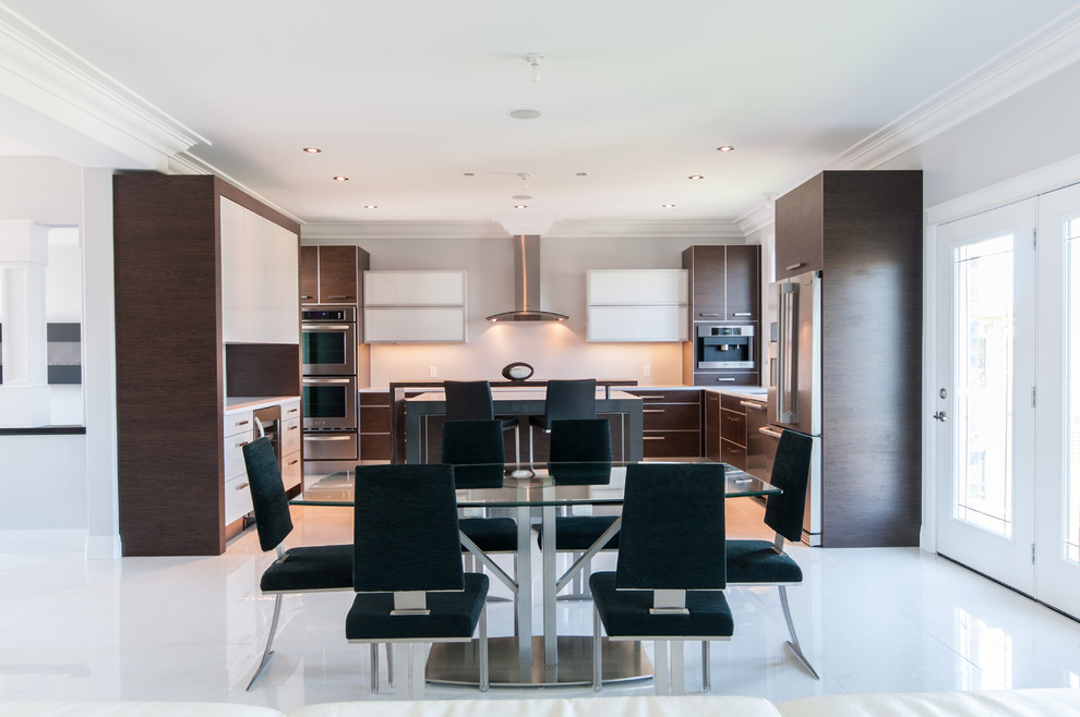 Photo of a large modern l-shaped eat-in kitchen in Toronto with an undermount sink, flat-panel cabinets, dark wood cabinets, solid surface benchtops, white splashback, porcelain splashback, stainless steel appliances, porcelain floors and with island.
