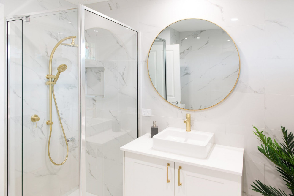 Photo of a mid-sized traditional master bathroom in Melbourne with shaker cabinets, white cabinets, a freestanding tub, a corner shower, black and white tile, porcelain tile, white walls, porcelain floors, a vessel sink, laminate benchtops, white floor, a hinged shower door, white benchtops, a single vanity and a built-in vanity.