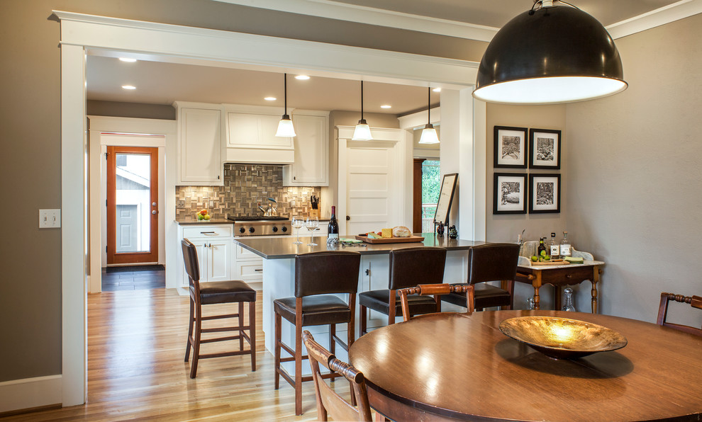 Photo of a mid-sized arts and crafts open plan dining in Portland with grey walls, light hardwood floors and no fireplace.
