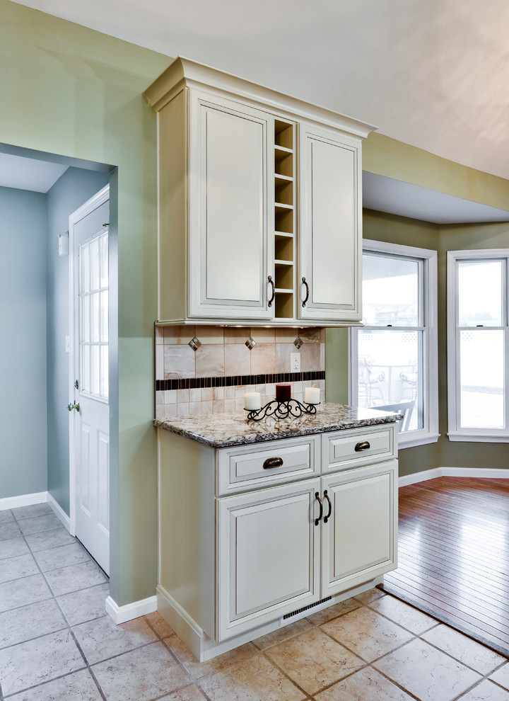 Inspiration for a mid-sized transitional galley open concept kitchen remodel with a double-bowl sink, beaded inset cabinets, white cabinets, wood countertops, beige backsplash, ceramic backsplash, stainless steel appliances and a peninsula