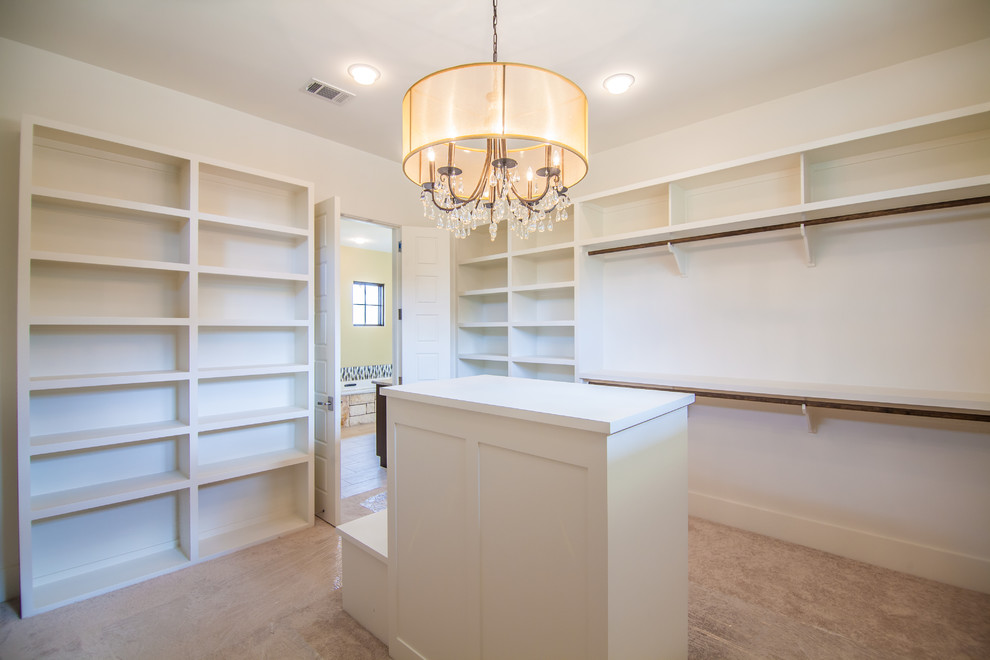 Expansive contemporary gender-neutral walk-in wardrobe in Austin with open cabinets, white cabinets, carpet and beige floor.