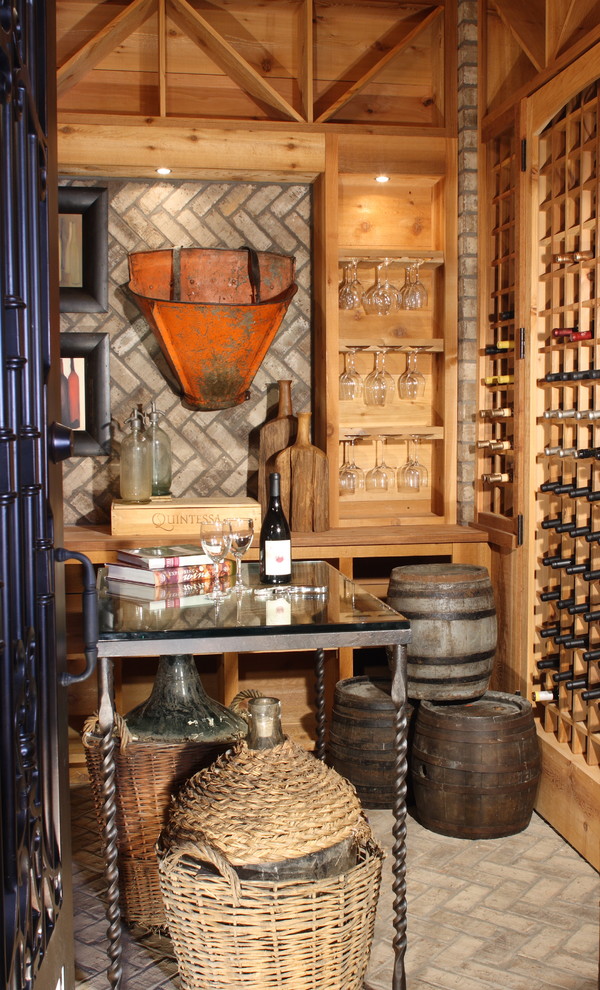 This is an example of a large traditional wine cellar in Atlanta with brick floors and storage racks.