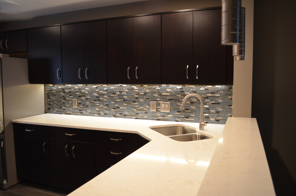 Mid-sized transitional u-shaped porcelain tile eat-in kitchen photo in Tampa with a double-bowl sink, flat-panel cabinets, dark wood cabinets, quartzite countertops, multicolored backsplash, matchstick tile backsplash, stainless steel appliances and an island