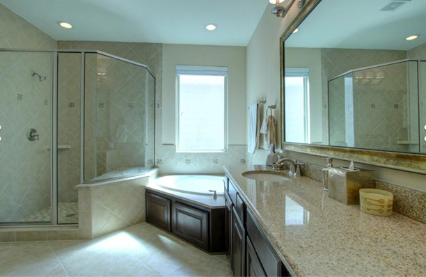 Inspiration for an arts and crafts master bathroom in Houston with granite benchtops, beige tile and porcelain floors.