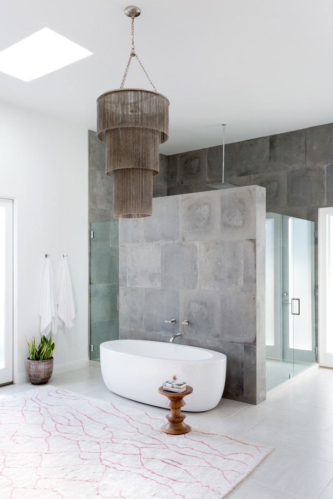 Inspiration for a large midcentury master bathroom in Los Angeles with a double shower, gray tile, white walls, a hinged shower door, a freestanding tub, ceramic floors and grey floor.