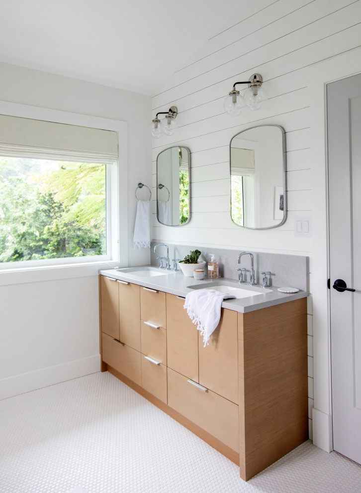 Photo of a transitional master bathroom in Vancouver with flat-panel cabinets, light wood cabinets, a freestanding tub, an alcove shower, a two-piece toilet, white tile, ceramic tile, white walls, ceramic floors, an undermount sink, engineered quartz benchtops, white floor, a hinged shower door and grey benchtops.