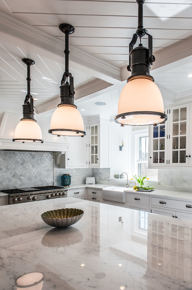 Example of a large transitional l-shaped medium tone wood floor and brown floor eat-in kitchen design in Boston with a farmhouse sink, shaker cabinets, white cabinets, granite countertops, gray backsplash, paneled appliances, an island and marble backsplash