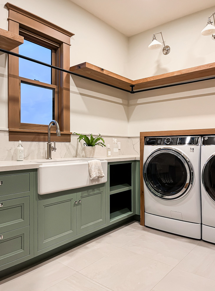 This is an example of a large classic u-shaped separated utility room in San Francisco with a belfast sink, recessed-panel cabinets, blue cabinets, engineered stone countertops, white splashback, engineered quartz splashback, white walls, porcelain flooring, a side by side washer and dryer, grey floors and white worktops.
