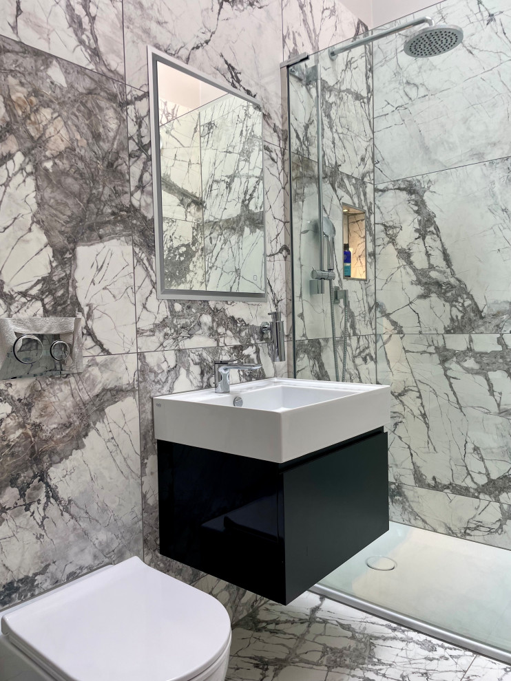 Inspiration for a medium sized contemporary ensuite bathroom in Hertfordshire with flat-panel cabinets, grey cabinets, a walk-in shower, a wall mounted toilet, porcelain tiles, porcelain flooring, a wall-mounted sink, an open shower, a single sink and a floating vanity unit.