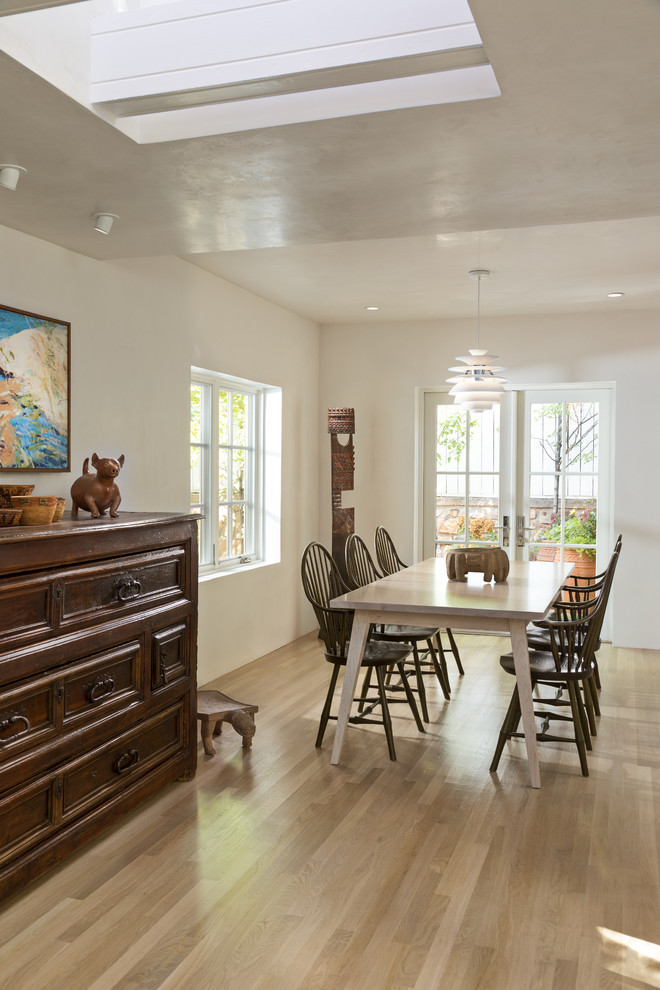 Inspiration for a mid-sized contemporary light wood floor and brown floor great room remodel in Albuquerque with white walls and no fireplace
