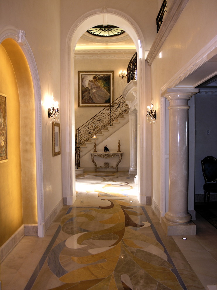 Design ideas for a traditional hallway in Los Angeles with beige walls, marble floors and multi-coloured floor.