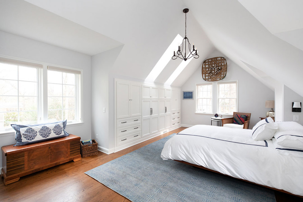 Inspiration for a large traditional master bedroom in Other with white walls, medium hardwood flooring, brown floors and a vaulted ceiling.